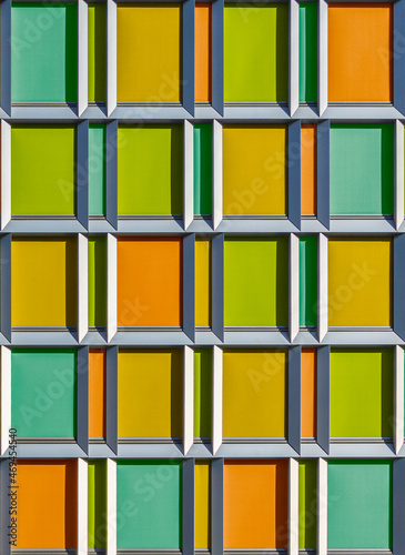 Colouful facade and building exterior. Background made of light orange, yellow, turquoise green rectangles. 