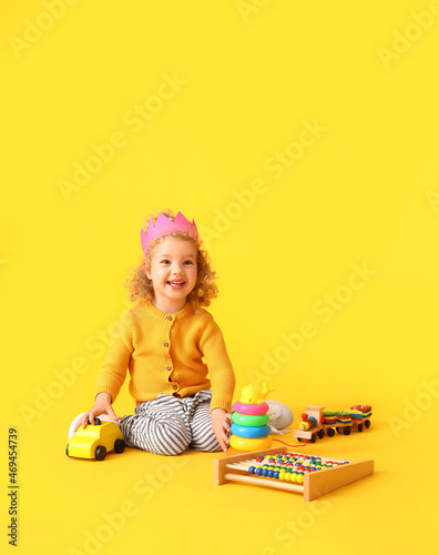 Cute baby girl with toys on...