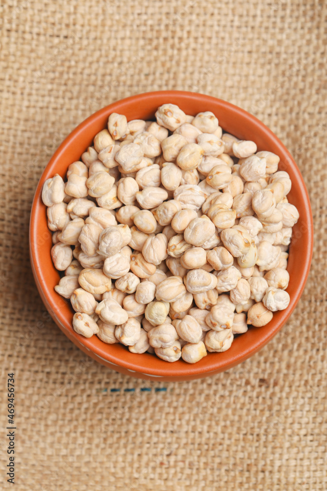 Dry chickpea in bowl on wooden background. Dry chickpea in bowl on wooden background.