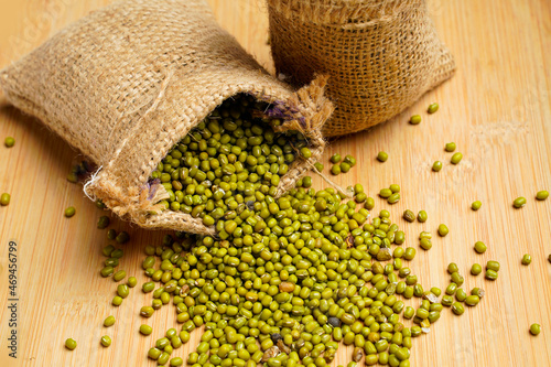 Green gram or mung bean in bag over white background.