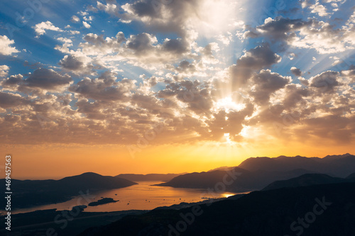 Orange sunset rays on the blue sky over the Bay of Kotor. View from Mount Lovcen