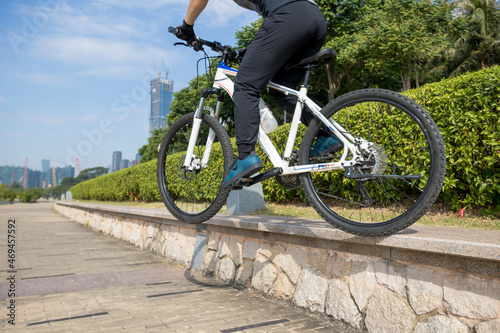 Riding bike jumping down stairs on the coast path