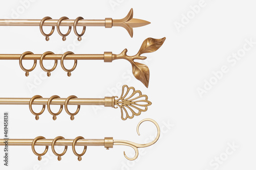 Set of metallic gold curtain rods isolated on a white background.
