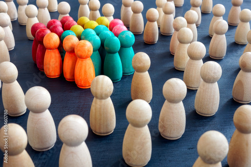 Social inclusion concept. Group color figurines and wooden ones. photo