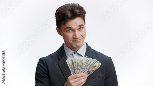 Good profit proposition. Young rich businessman offering money to you, showing and shaking bunch of money photo