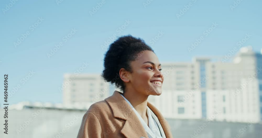 An african american woman is walking through the downtown and smile An african american woman is walking through the downtown and smile