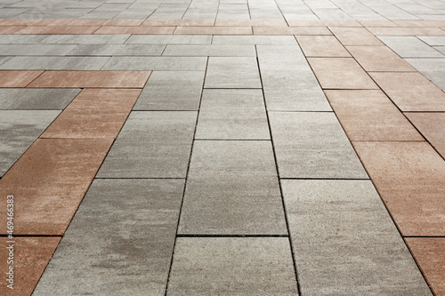 Creation of markings on the sidewalk from slabs of different colors. Selective focusing.