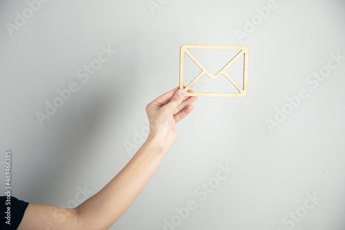 woman holding wooden envelope letter sign