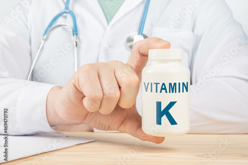Essential vitamin K and minerals for humans. doctor recommends taking vitamin K. doctor talks about Benefits of vitamin K. K Vitamin - Health Concept