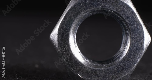 Screw close-up on a dark background. Fastener full face.