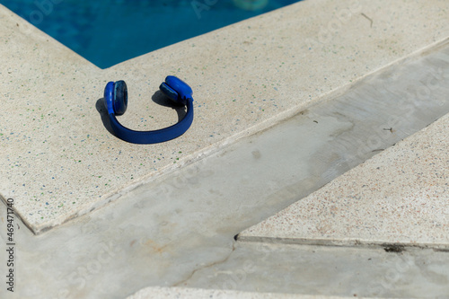 blue earphones close up near swimming pool