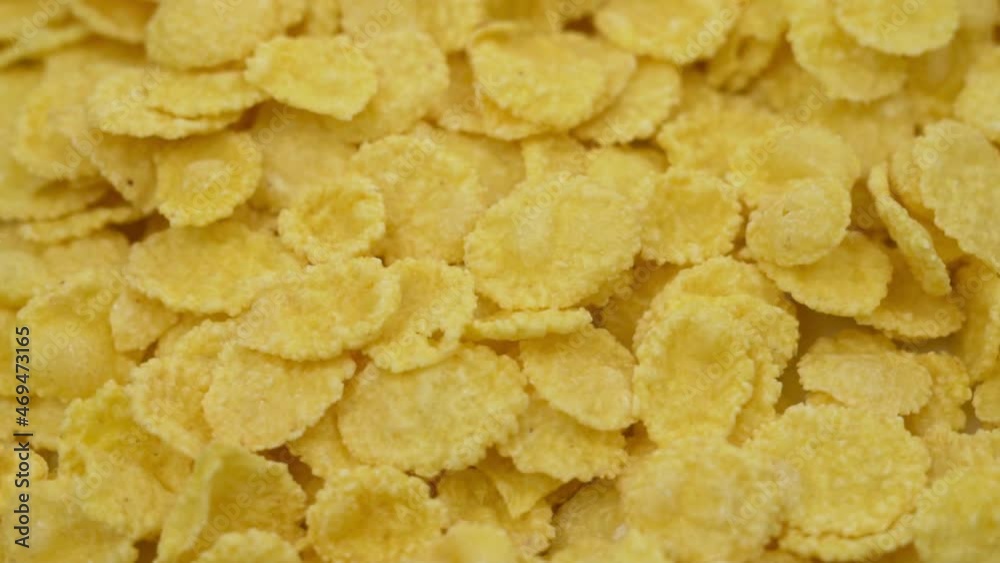 Flakes, Cornflakes, Macro, Close-up. Rotation Of Cornflakes. Flakes Are Isolated. Healthy Breakfast, Vegetarian Food. Cornflakes background. Flakes, Cornflakes, Macro, Close-up. Rotation Of Cornflakes. Flakes Are Isolated. Healthy Breakfast, Vegetarian Food. Cornflakes background.