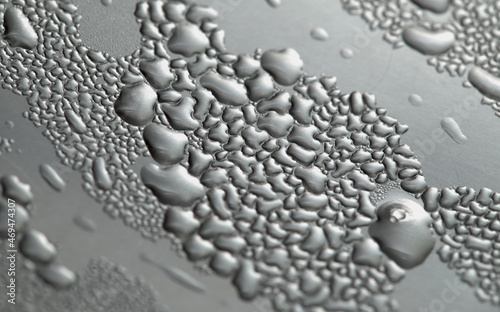 Macro background with water droplets condensation pattern on metal surface  
