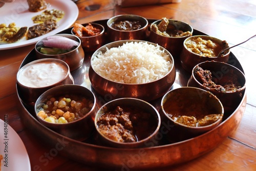 Dham - Traditional food of Himachal Pradesh. Himachali kangri dham thali includes Kaddu ka khatta, Chane ka Madra, sepu vadi, maash dal, Rajma, salad, rice, or Mitha Bhaat. served with Roti and pickle