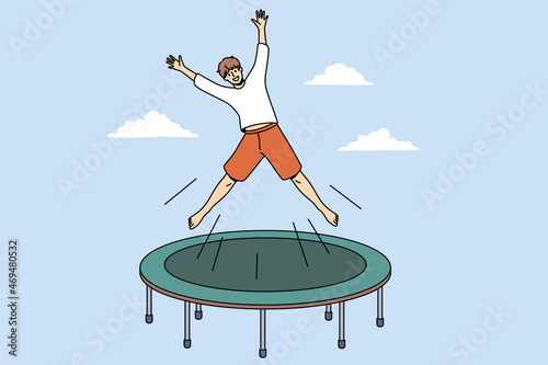 Summer activity and leisure concept. Smiling excited boy cartoon character jumping on trampoline outdoors feeling playful vector illustration