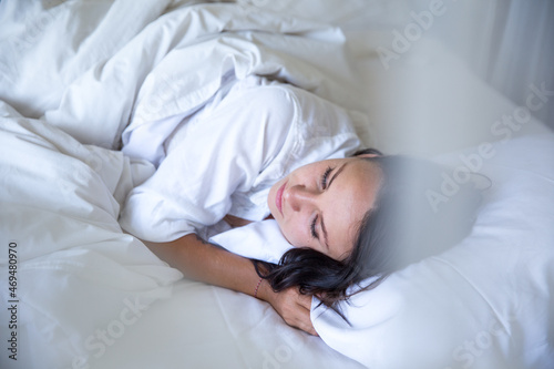 beautiful woman sleeping in white bed in the morning.