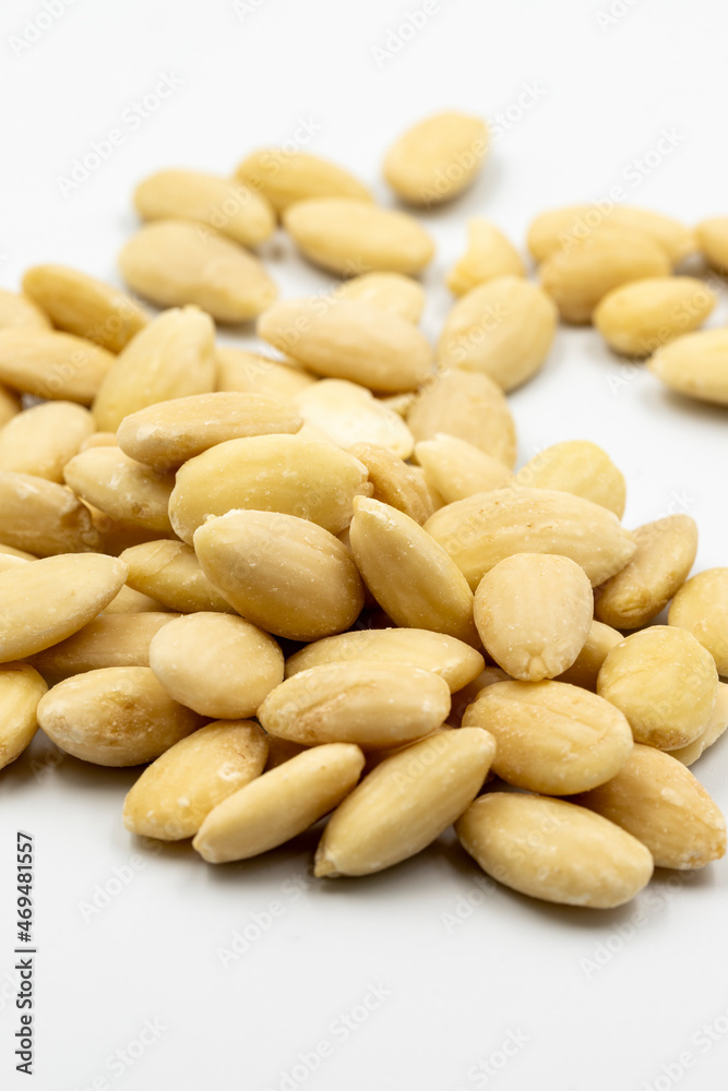 Peeled almond kernel isolated on white background. Snack fresh nuts. close up story format Peeled almond kernel isolated on white background. Snack fresh nuts. close up story format