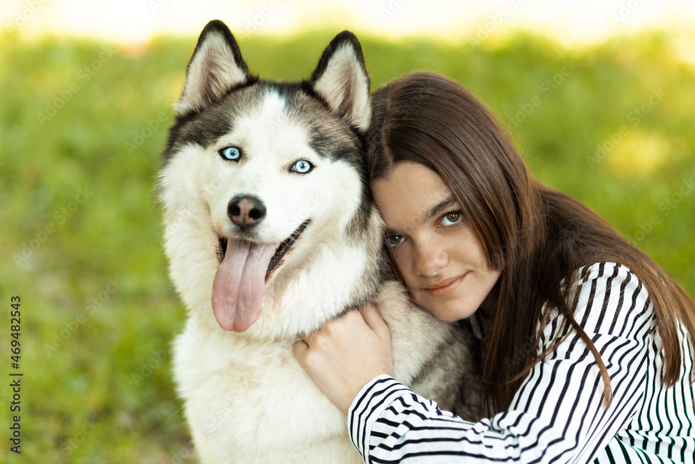 Portrait of a girl with a husky dog. Rehabilitation with pets.