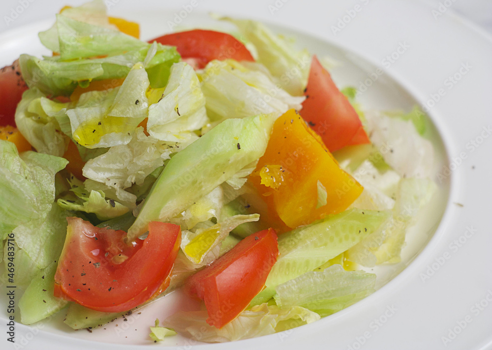 Salad with tomatoes, cucumber, pumpkin, cabbage in a plate. Closeup Salad with tomatoes, cucumber, pumpkin, cabbage in a plate. Closeup