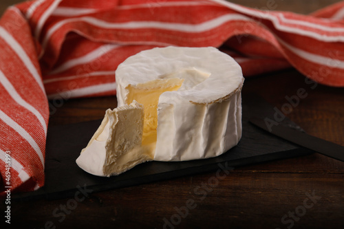 French cheese Brillat Savarin on wooden background