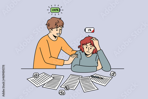 Low and full energy people concept. Young smiling man with full energy battery standing supporting tired stressed low energy woman sitting at table vector illustration 