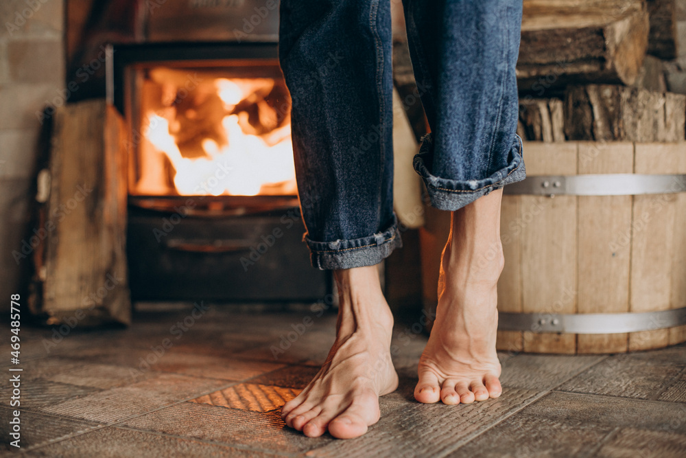 Female legs by fire place in sauna Female legs by fire place in sauna