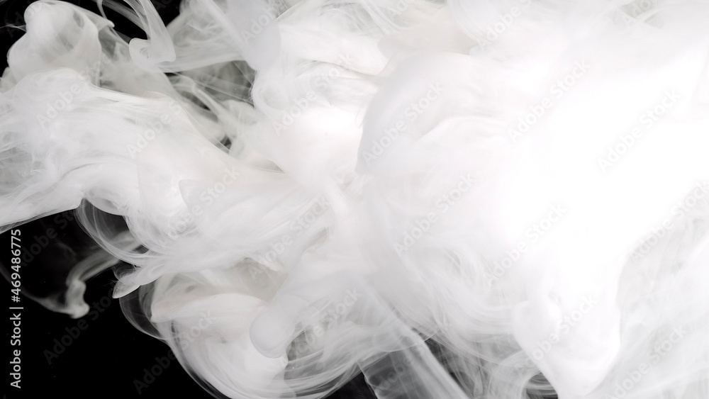 White acrylic ink in water on a black background. Environmental pollution concept. White cloud of ink. Meditative background. White acrylic ink in water on a black background. Environmental pollution concept. White cloud of ink. Meditative background.
