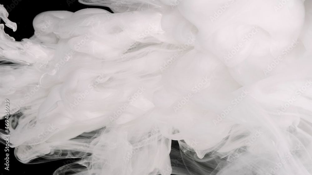 White cloud of ink. White watercolor ink mixed in water on a black background. White cloud of ink. White watercolor ink mixed in water on a black background.