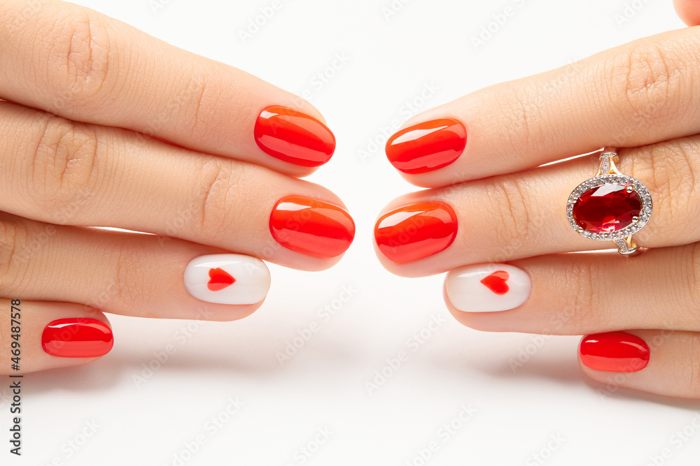 Womans hands with fashionable red manicure on white background. Manicure, pedicure beauty salon concept Womans hands with fashionable red manicure on white background. Manicure, pedicure beauty salon concept