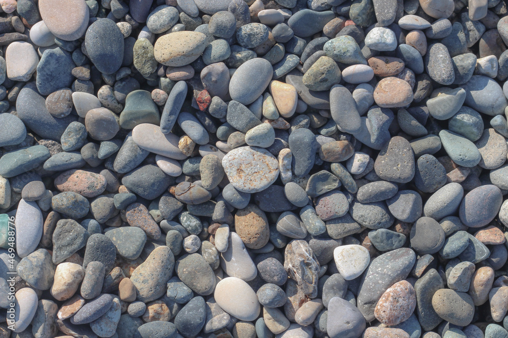 Natural beach rocky textured detailed background in a light of sun. Natural beach rocky textured detailed background in a light of sun.