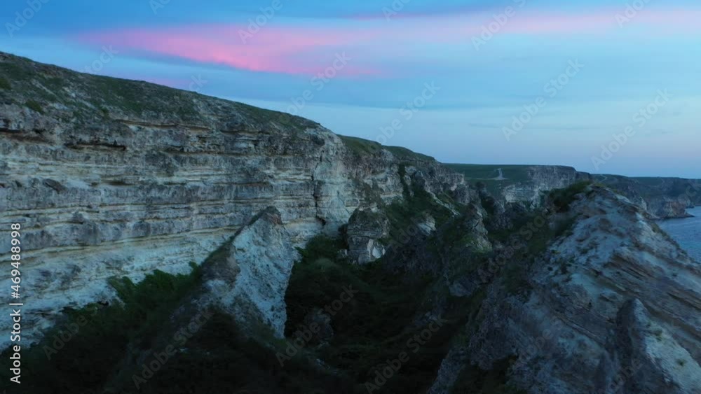 Rocky coastline Dzhangul aerial view at blue hour. Beautiful steep shore and sea landscape at dusk Rocky coastline Dzhangul aerial view at blue hour. Beautiful steep shore and sea landscape at dusk