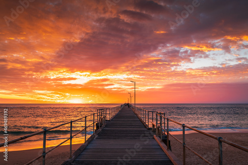 Port Noarlunga beach pier with people at sunset