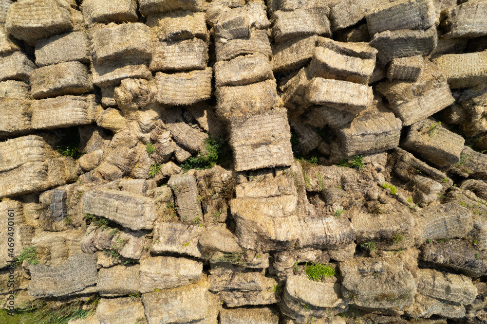 Naklejka premium Flying over the large open warehouse of straw bales on an industrial scale. Ukraine