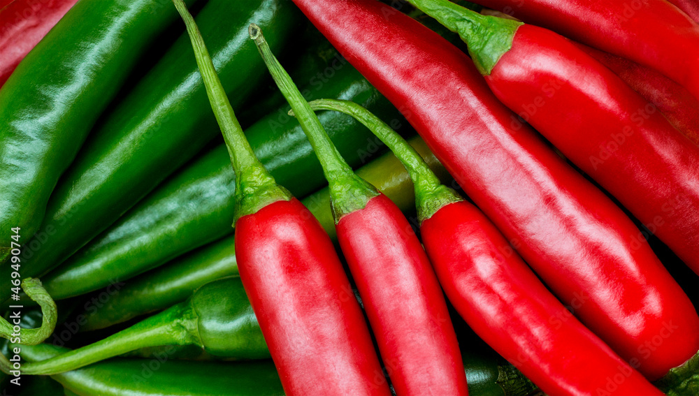 Group of both red and green freshly picked ripe chili peppers. Red chilies contain large amounts of vitamin C and small amounts of carotene (provitamin A).