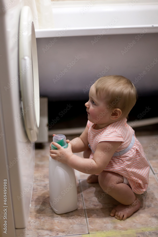 small child and washing machine in bathroom small child and washing machine in bathroom