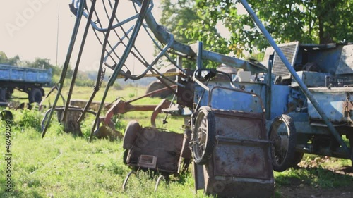 Various very old, aged, abandoned and rusty rural blue colored technique and equipment view filmed in different focal length in late summer sunset background