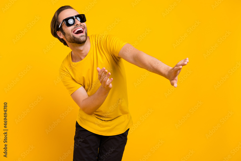 Naklejka premium Photo of young cheerful man have fun dancing wear casual outfit isolated over yellow color background