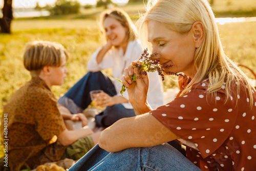 White family smiling during picnic on summer field