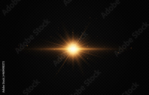 Brights golden flashe on black background. Shining stars, beautiful golden rays. Optical flare. photo