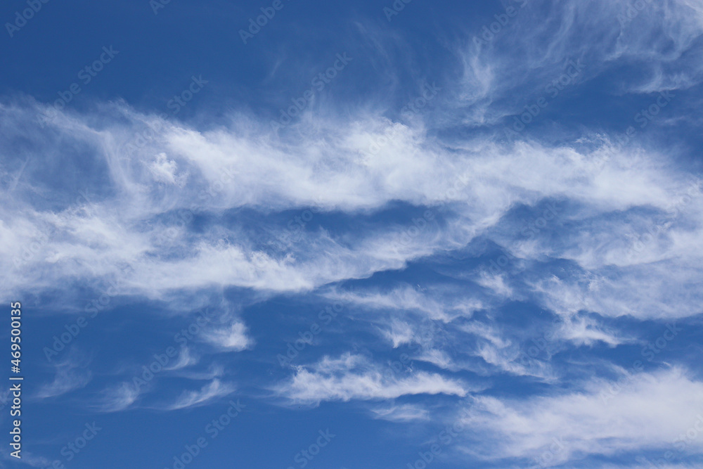 White clouds against blue sky, during a bright Summer day.