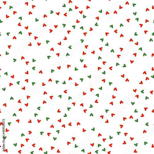 Seamless pattern with Christmas decoration. Green and red tiny heart pattern.