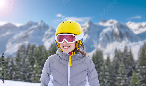 Smiling little girl on the high altitude ski slope in the Italian Alps. Happy little girl with helmet and ski goggles on the ski slopes. © trattieritratti