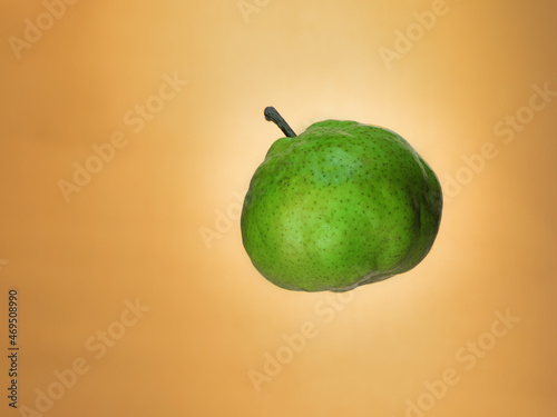 Levitating pear on orange background