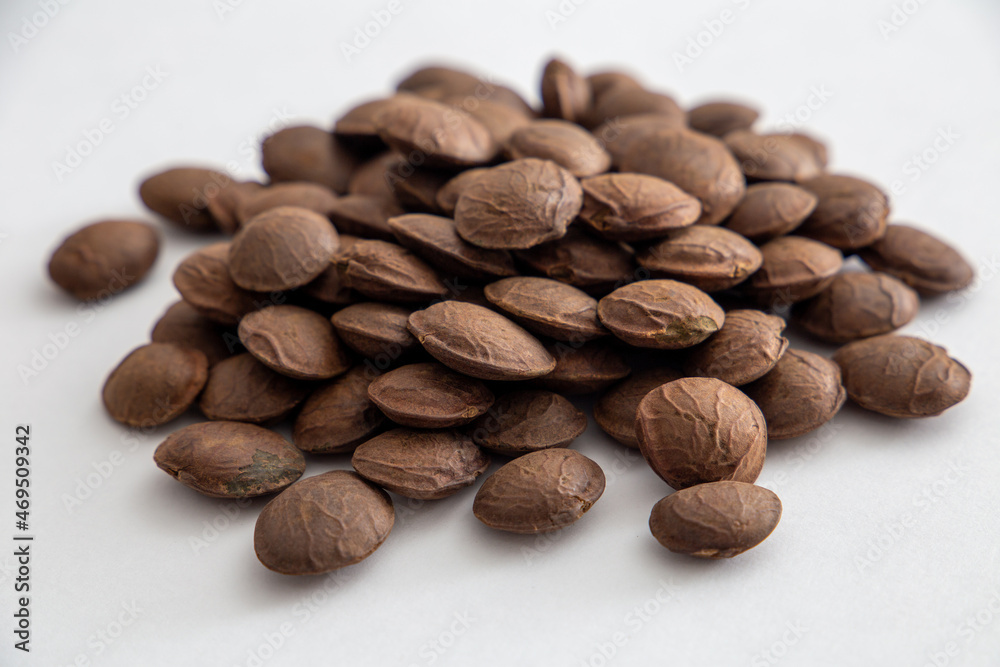 Sacha Inchi roasted seed nuts, selective focus on front seeds, on white background Sacha Inchi roasted seed nuts, selective focus on front seeds, on white background