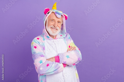 Portrait of attractive cheerful grey-haired man wearing kigurumi folded arms isolated over violet purple color background