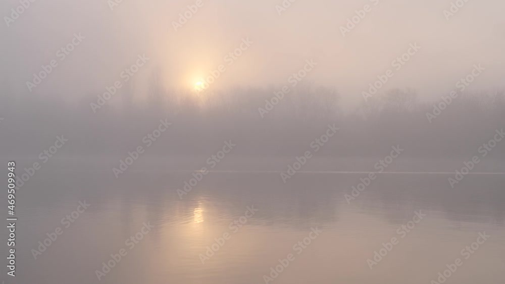 fog over the river a fisherman in a boat at sunset in November fog over the river a fisherman in a boat at sunset in November