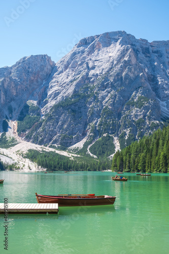 Lake Braies (also known as Pragser Wildsee or Lago di Braies) in Dolomites Mountains, Sudtirol, Italy. Romantic place with typical wooden boats on the alpine lake. Hiking travel and adventure.