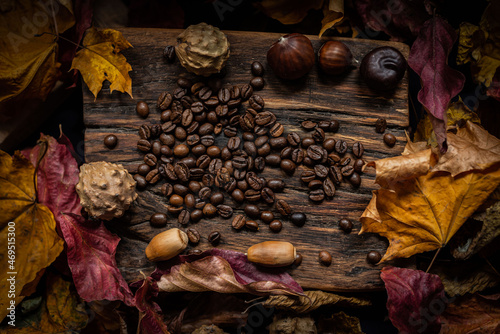 autumn leaves with coffee beans on rustic wood