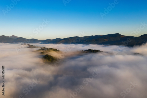 Beautiful landscape with thick mist in mountains. Drone photography