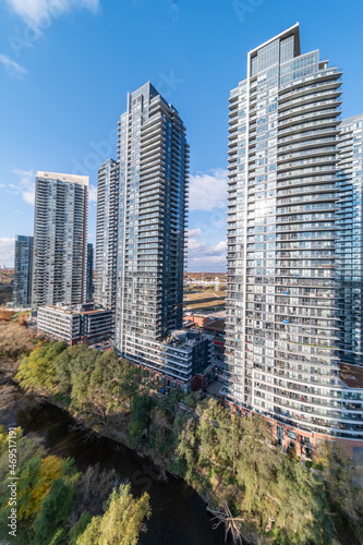 Drone Views of condos and Humber bay shores with  brown trees tops Fall colours by Parklawn rd and lakeshore   with blue skies and broken clouds  photo